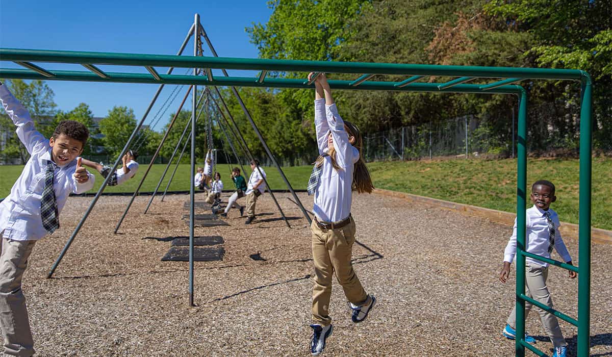 Manassas Christian School, Our Campus, picture of students playing on the school playgrounds monkey bars